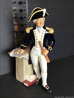Front view of Royal Doulton The Captain figurine with telescope, map table, and book