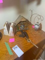 overview of bookends, cuckoo clock, ornament on stand