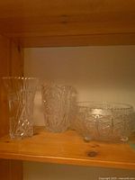 Overall view of two vases and footed bowl on shelf