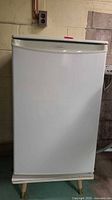 Front view of white Danby bar fridge