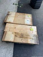 Two wood plank dollies side by side