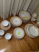 Stacked dinner, luncheon and soup bowls with teapot, sugar bowl visible