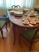 Full view of Gibbard Chantilly dining table with dishes on top