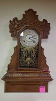 Front view of carved wood gingerbread wall clock