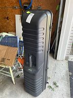 Full view of hard resin golf case standing upright