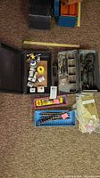 Overview of lot with cases, trays, drill bits and metal sheets