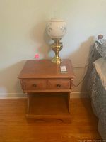 Full view of nightstand with lamp on top
