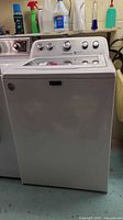 Front view of Maytag Bravos washer showing glass lid and control panel