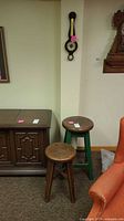 Two stools, barometer on wall