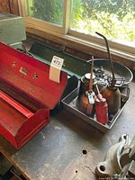 Red toolbox open showing interior tray and wear