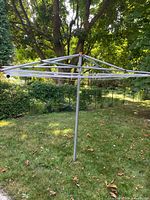 Full view of umbrella clothesline in yard