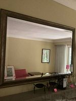 Full view of rectangular mirror on wall, showing frame style and size