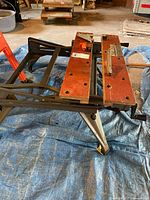 Full view of Workmate workbench showing wooden clamp jaws, metal frame and hand crank
