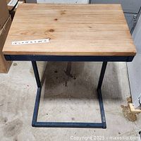 Front angled view showing wood top and metal frame