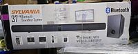 Retail box front showing Sylvania 37" Bluetooth Soundbar System with wireless subwoofer