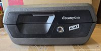 Front view of SentrySafe lockbox showing handle, logo, key lock