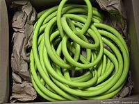 Coiled bright green hose in box