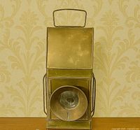 Front view showing hinged top, reflector, handle