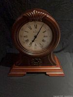 Front view of Bulova Westminster mantel clock showing dial, case and base