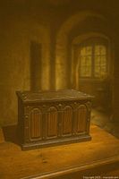 Closed carved wooden jewelry box on table