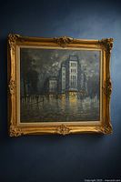 Front view of framed A. Petrin painting on dark wall