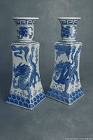 front three-quarter view of both vases showing dragon designs and form