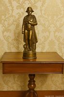 Full view of bronze Napoleon statue on pedestal table