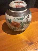 Front view of ginger jar showing phoenix and floral design with crackle glaze and metallic banding