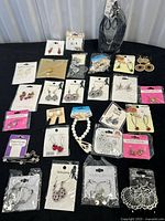 Full layout of 28 sealed costume-jewelry packages