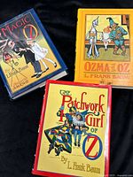 All three hardcover Oz books arranged on black background