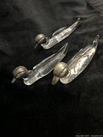 Three glass duck utensil rests side view