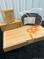 Four boxed Pampered Chef items stacked together