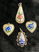 group shot of four enamel sterling pendants
