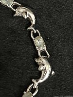 Close-up of dolphin and stone links