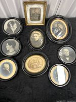 Group shot of all nine framed photographs displayed on table