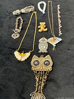 Full layout of all nine jewelry pieces on black cloth