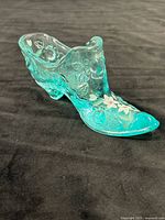 Full view of teal art glass slipper shoe showing overall shape and color
