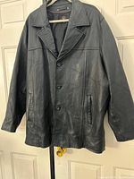 Full front view of jacket on hanger showing overall style and length