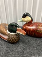 Both wooden duck decoys front angle