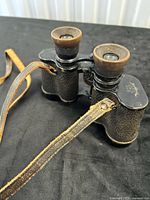 Top view of SOLUX 6x30 binoculars showing eyepieces and leather strap