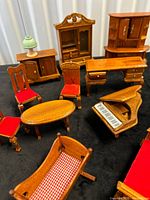 Group view of multiple wooden miniature furniture pieces