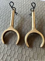 Front view of both brass oar locks with clips attached