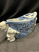 Overall view showing curved top, figural child support and pierced body