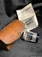 Magnifier, leather case, booklet grouped
