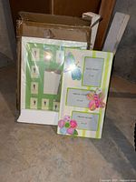 Pottery Barn Kids collage frame in packaging beside Direct International butterfly frame