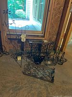 Group view of all wrought iron pieces on basement floor