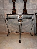 Front view showing entire metal and glass demilune table