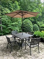 full patio set showing table chairs and umbrella