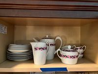 Full set on shelf: plates stack, teapot, creamer, sugar bowl