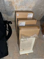 Three sealed Pottery Barn Kids boxes containing book easels